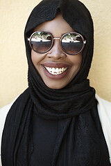 Image showing african woman using smartphone wearing traditional islamic clothes