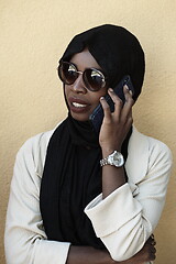 Image showing african woman using smartphone wearing traditional islamic clothes