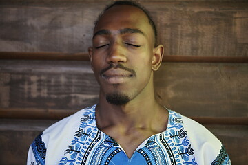 Image showing portrait of a smiling young african man wearing traditioinal clothes