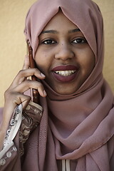 Image showing african woman using smartphone wearing traditional islamic clothes