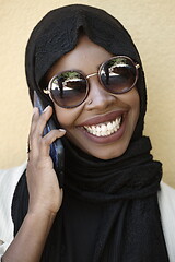 Image showing african woman using smartphone wearing traditional islamic clothes