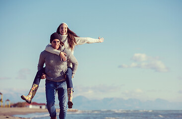 Image showing couple having fun at beach during autumn