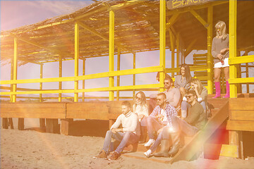 Image showing Group of friends having fun on autumn day at beach