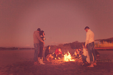 Image showing Friends having fun at beach on autumn day