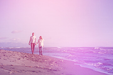 Image showing Loving young couple on a beach at autumn sunny day