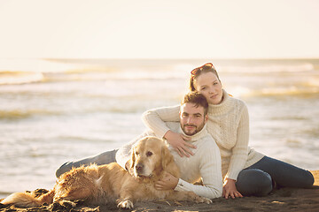 Image showing Couple with dog enjoying time on beach