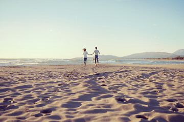 Image showing couple with dog having fun on beach on autmun day