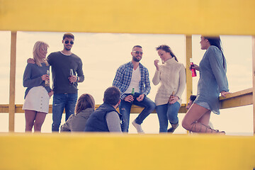 Image showing Group of friends having fun on autumn day at beach