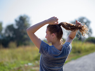 Image showing woman jogging along a country road