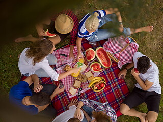 Image showing top view of group friends enjoying picnic time