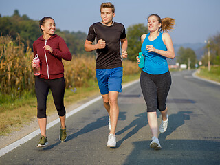 Image showing young people jogging on country road