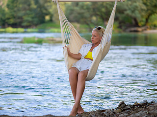 Image showing blonde woman resting on hammock