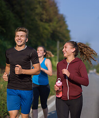 Image showing young people jogging on country road