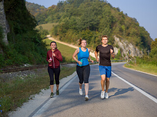 Image showing young people jogging on country road