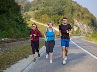 Image showing young people jogging on country road