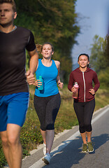 Image showing young people jogging on country road