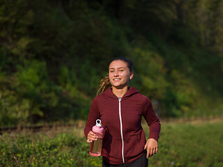 Image showing woman jogging along a country road