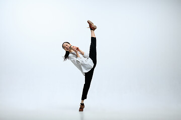 Image showing Woman working at office and jumping isolated on studio background