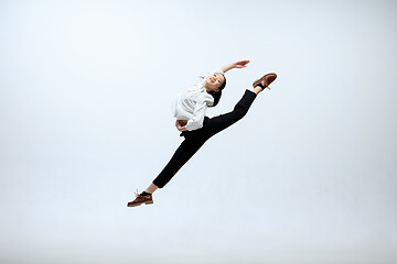 Image showing Woman working at office and jumping isolated on studio background