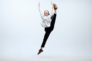 Image showing Woman working at office and jumping isolated on studio background