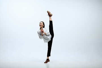 Image showing Woman working at office and jumping isolated on studio background