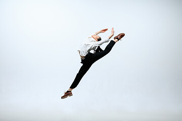 Image showing Woman working at office and jumping isolated on studio background