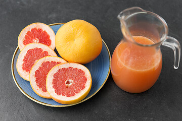 Image showing jug of fruit juice with grapefruits on plate