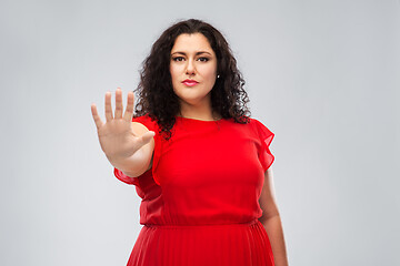 Image showing woman in red dress showing stop gesture