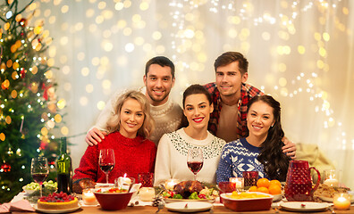 Image showing happy friends celebrating christmas at home