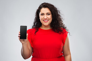 Image showing happy woman in red dress showing smartphone