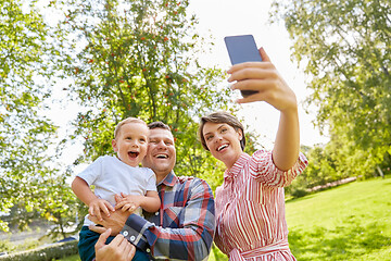 Image showing happy family taking selfie at summer park