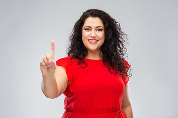 Image showing happy woman in red dress showing one finger