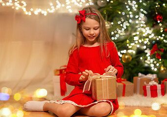 Image showing smiling girl with christmas gift at home