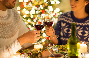 Image showing happy couple drinking red wine at christmas dinner