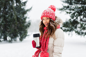 Image showing young woman with hot drink in tumbler in winter