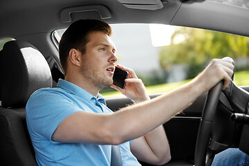 Image showing man driving car and calling on smartphone