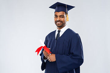 Image showing male graduate student in mortar board with diploma