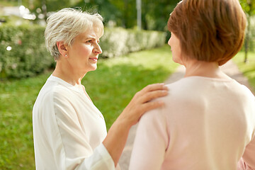 Image showing senior women or friends talking at summer park