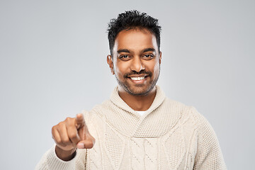 Image showing smiling indian man pointing finger to camera