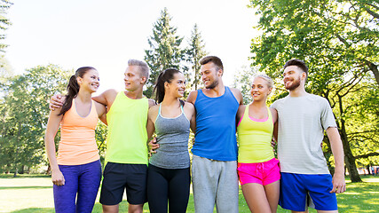 Image showing group of happy friends or sportsmen at summer park