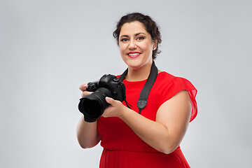 Image showing happy woman photographer with digital camera