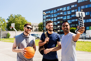 Image showing happy men taking selfie at basketball playground