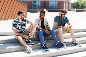 Image showing happy male friends drinking beer on street