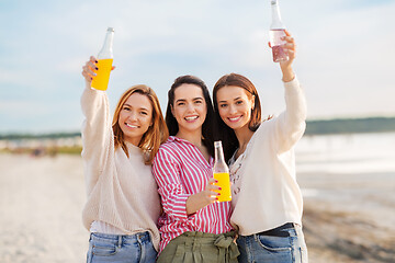 Image showing young women toasting non alcoholic drinks on beach