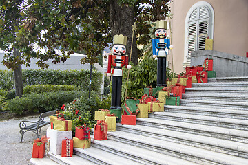 Image showing Wooden figures of the Nutcracker and gift boxes as Christmas dec