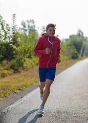 Image showing man jogging along a country road