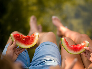 Image showing Couple eating watermelon enjoying picnic time