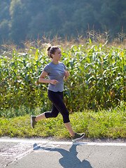 Image showing woman jogging along a country road