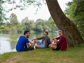 Image showing men sitting on the bank of the river