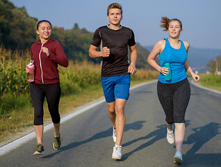 Image showing young people jogging on country road